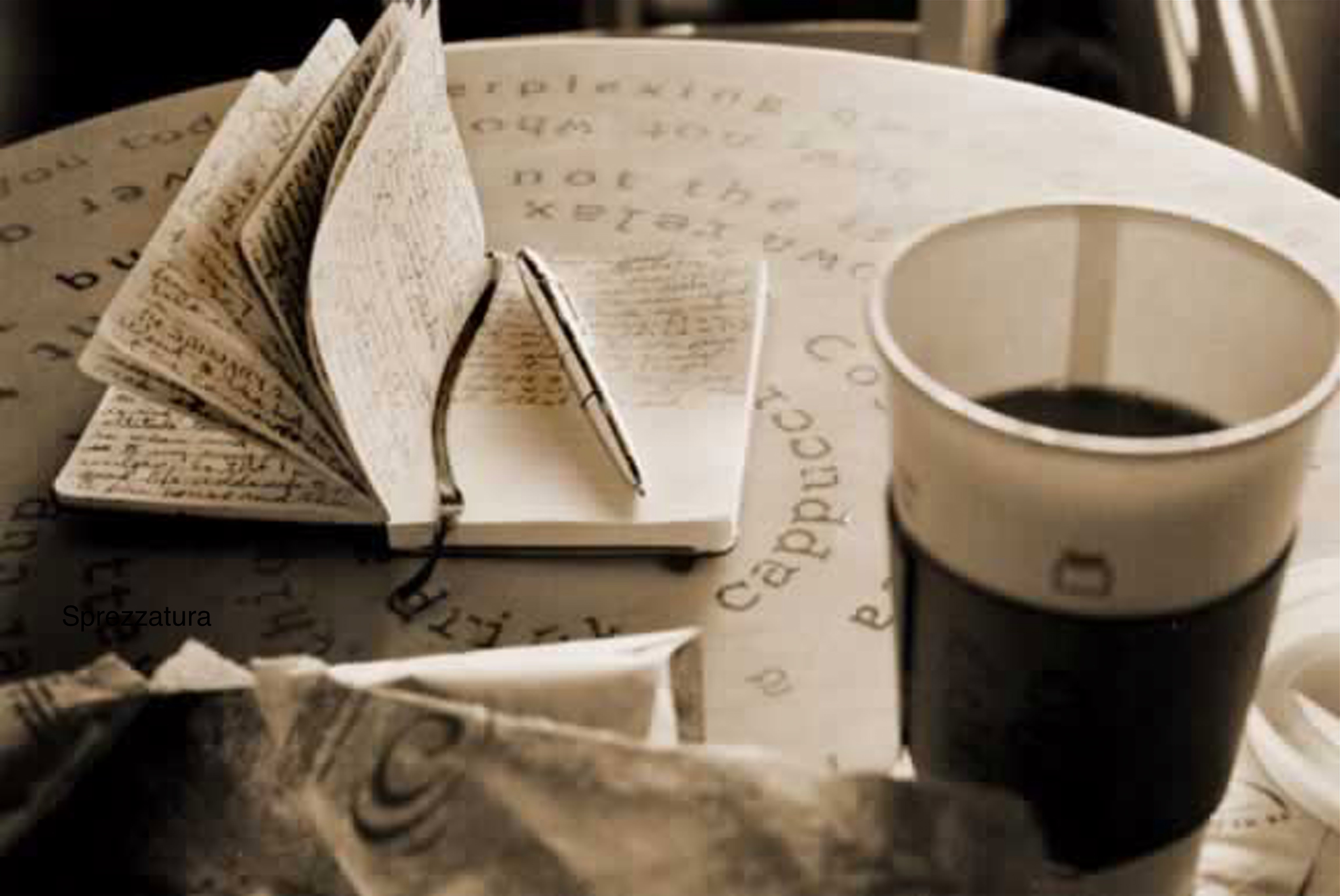 Photo of notebook with pen and coffee cup